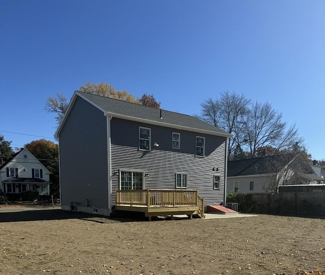 rear view of house featuring a wooden deck