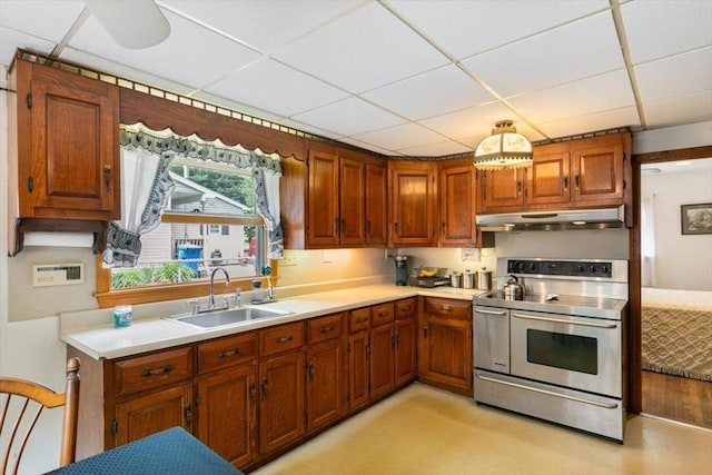 72 Heath St, Tewksbury, MA 01876 - kitchen featuring stainless steel range with electric stovetop, under cabinet range hood, a sink, a drop ceiling, and light countertops