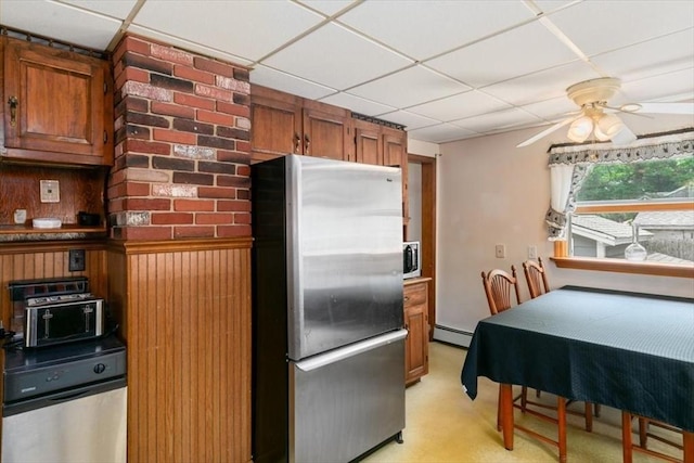 72 Heath St, Tewksbury, MA 01876 - kitchen featuring appliances with stainless steel finishes, baseboard heating, brown cabinets, a drop ceiling, and ceiling fan
