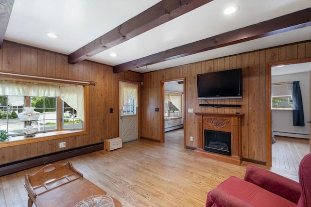 72 Heath St, Tewksbury, MA 01876 - living area with a baseboard radiator, baseboard heating, light wood-type flooring, beam ceiling, and a fireplace with raised hearth