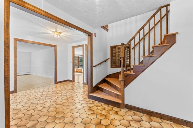 entryway with stairway, a textured ceiling, baseboards, and a baseboard radiator