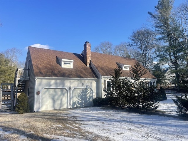 view of snow covered exterior featuring a garage