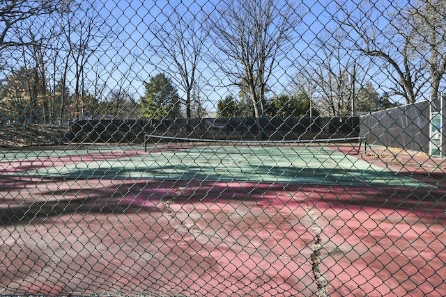 view of sport court featuring fence