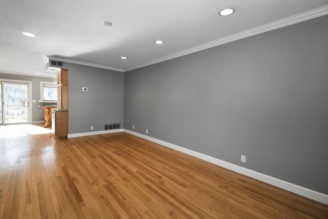 unfurnished room featuring visible vents, baseboards, ornamental molding, recessed lighting, and hardwood / wood-style flooring