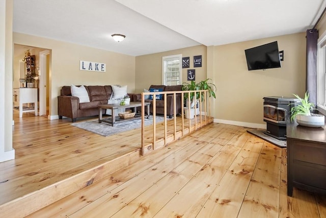 27 Lakeview St, Southwick, MA 01077 - living room with wood-type flooring, baseboards, and a wood stove