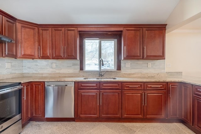 kitchen featuring sink, appliances with stainless steel finishes, light stone counters, decorative backsplash, and vaulted ceiling