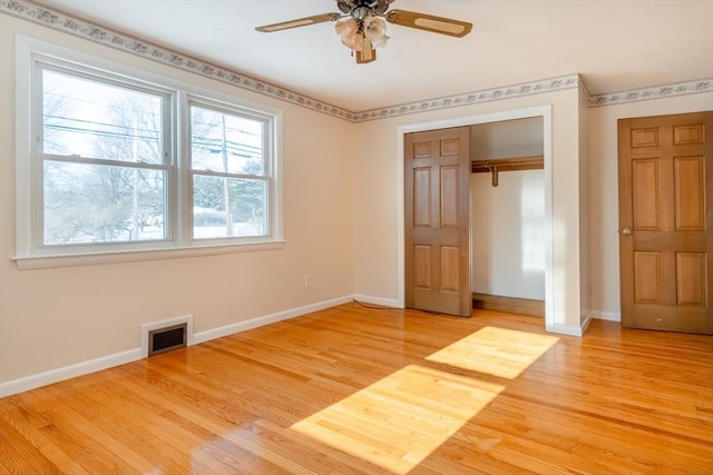 unfurnished bedroom featuring ceiling fan, a closet, and light wood-type flooring