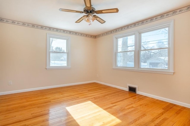 spare room with ceiling fan and light wood-type flooring