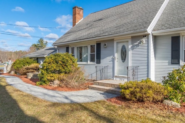 doorway to property with a lawn