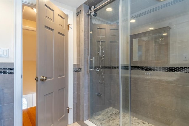 bathroom with a shower with door