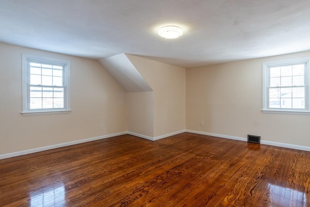 additional living space featuring dark hardwood / wood-style floors and vaulted ceiling