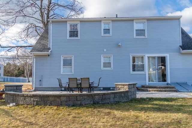 back of property featuring a yard and a patio