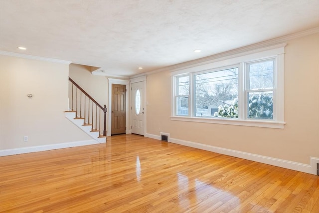 interior space featuring crown molding and light hardwood / wood-style floors