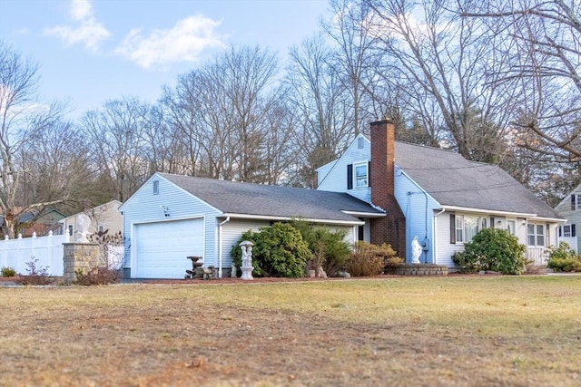 view of side of home with a yard and a garage