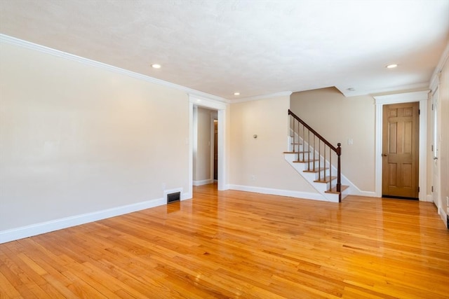 spare room with crown molding and light hardwood / wood-style floors