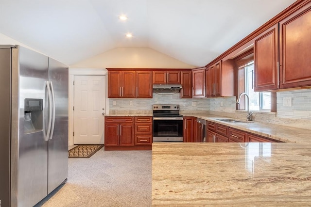 kitchen featuring vaulted ceiling, tasteful backsplash, sink, stainless steel appliances, and light stone countertops