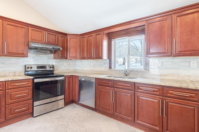 kitchen with lofted ceiling, sink, tasteful backsplash, stainless steel appliances, and light stone countertops