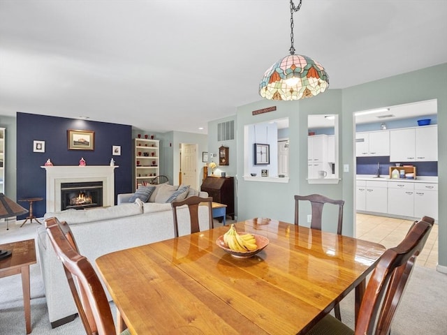 carpeted dining room featuring built in features