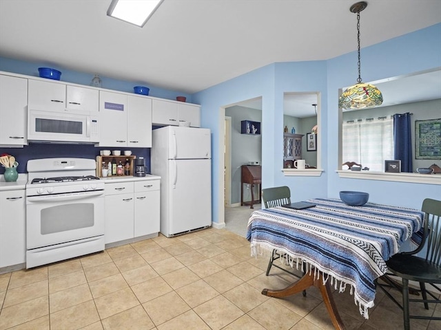 kitchen featuring white cabinetry, white appliances, light tile patterned floors, and decorative light fixtures