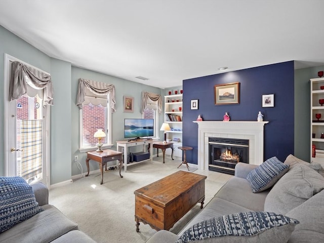 carpeted living room featuring built in shelves