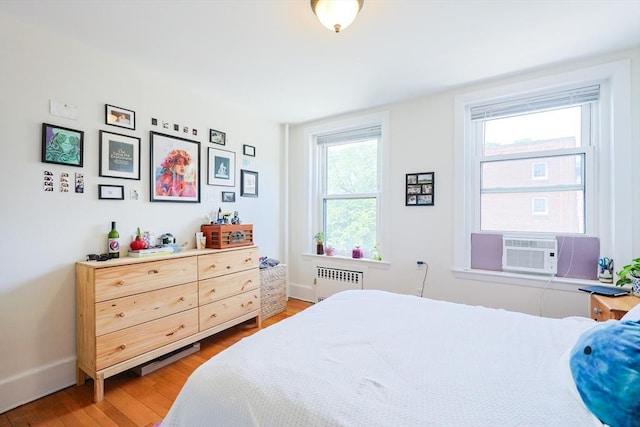 33 Saint Paul St Unit 3, Brookline, MA 02446 - bedroom featuring radiator heating unit, wood finished floors, and cooling unit