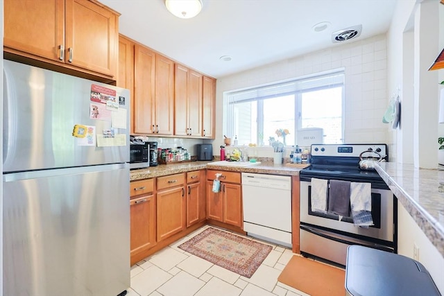 33 Saint Paul St Unit 3, Brookline, MA 02446 - kitchen featuring appliances with stainless steel finishes, light countertops, and light tile patterned flooring