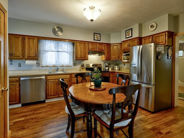 27 Newton Ave, Lynn, MA 01905 - kitchen featuring appliances with stainless steel finishes, under cabinet range hood, light countertops, and brown cabinetry
