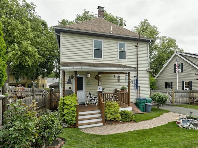 27 Newton Ave, Lynn, MA 01905 - rear view of property with a fenced backyard, a chimney, a shingled roof, and a porch