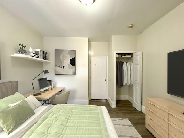 bedroom with dark hardwood / wood-style floors and a closet