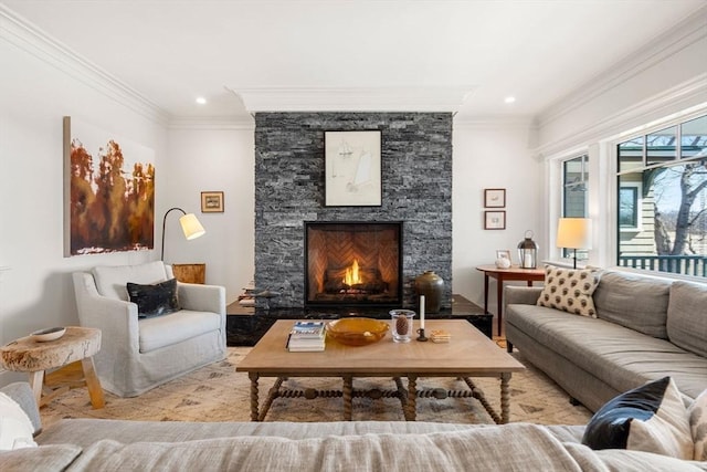 living area with a stone fireplace, recessed lighting, crown molding, and wood finished floors