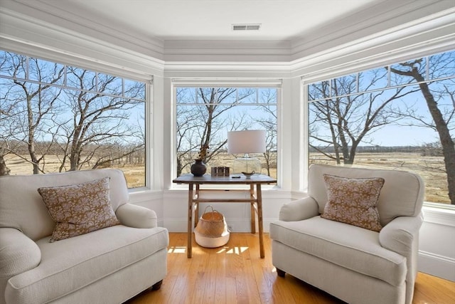 living area featuring hardwood / wood-style floors and visible vents