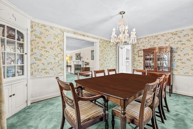 carpeted dining room featuring crown molding and a chandelier