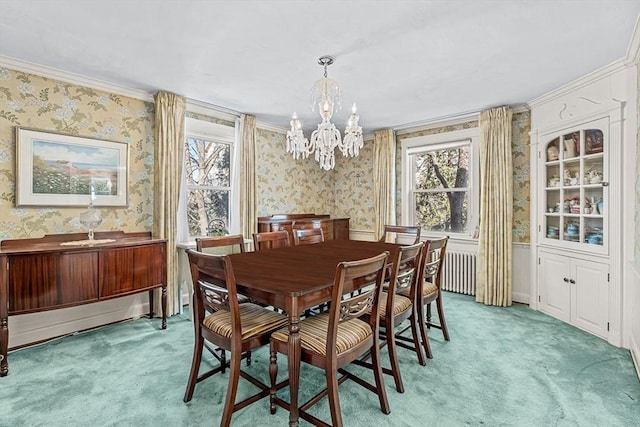 carpeted dining area featuring a notable chandelier, a wealth of natural light, and ornamental molding