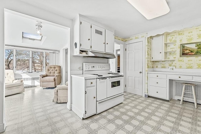 kitchen with range with two ovens, white cabinetry, and radiator