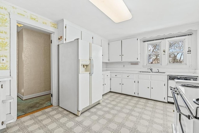 kitchen featuring white cabinetry, sink, white fridge with ice dispenser, and range