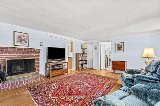 living room with wood-type flooring and a fireplace