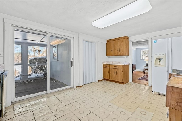 kitchen featuring white fridge with ice dispenser