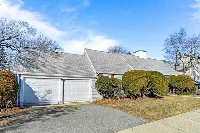 view of front facade with a garage and a front lawn