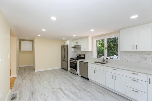 43 Hobart Ter, Braintree, MA 02184 - kitchen featuring appliances with stainless steel finishes, under cabinet range hood, decorative backsplash, white cabinetry, and recessed lighting