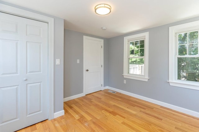 43 Hobart Ter, Braintree, MA 02184 - unfurnished bedroom with light wood-style flooring and multiple windows
