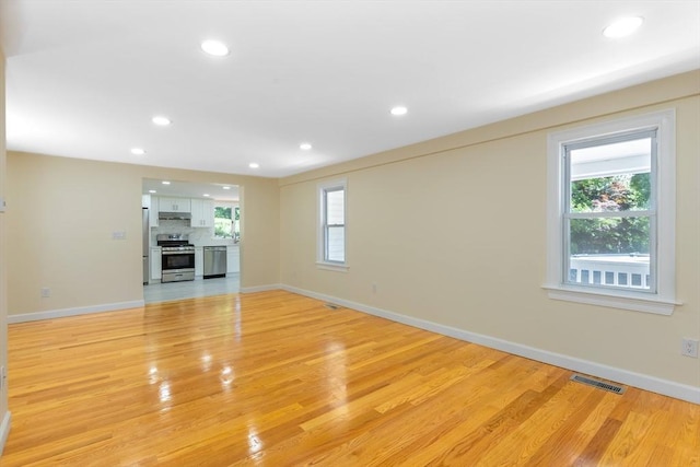 43 Hobart Ter, Braintree, MA 02184 - unfurnished living room featuring light wood-style floors, recessed lighting, and healthy amount of natural light