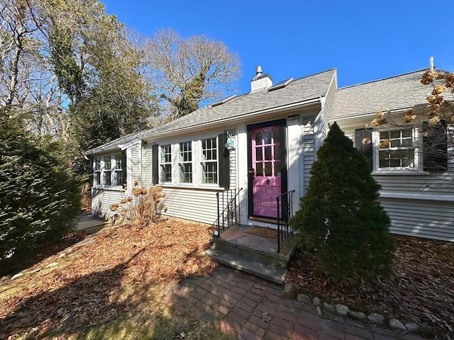 single story home featuring a chimney