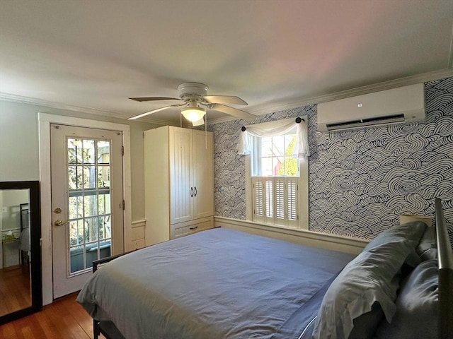 bedroom featuring ornamental molding, a ceiling fan, wood finished floors, a wall unit AC, and wallpapered walls