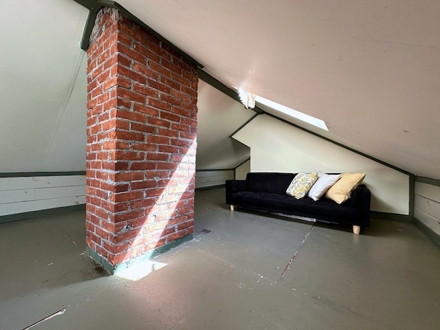 interior space featuring lofted ceiling, visible vents, and concrete floors