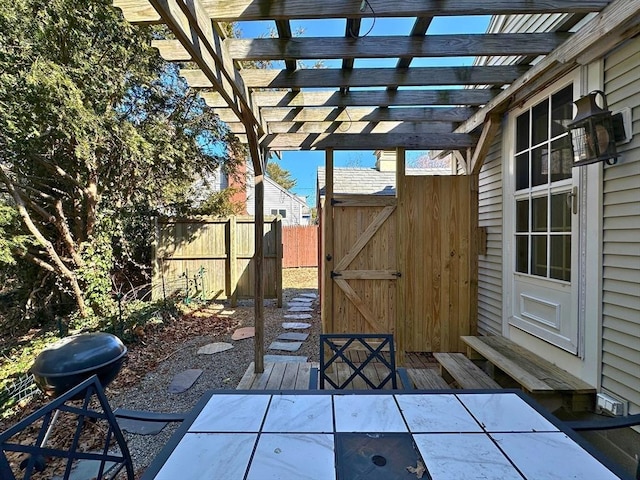 view of patio / terrace with outdoor dining area, fence, and a pergola