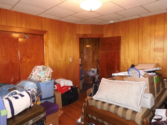 bedroom with wood finished floors and wooden walls