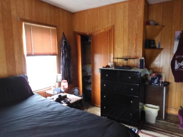 bedroom featuring wood walls