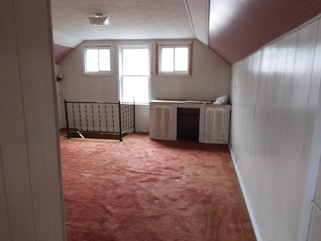 bonus room with carpet flooring, vaulted ceiling, and a wealth of natural light