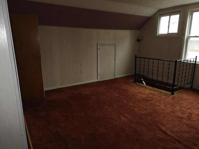 bonus room with carpet floors and vaulted ceiling