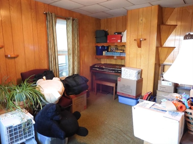 sitting room featuring carpet and wood walls